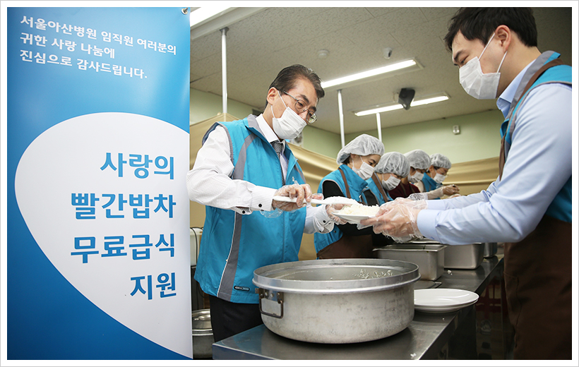 서울아산병원 직원들이 서울역 따스한 채움터에서 무료 급식 지원을 하고 있다.